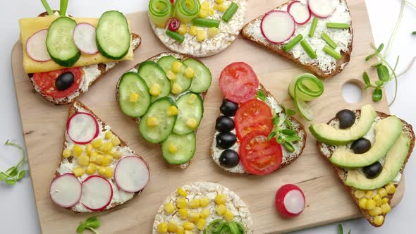 Vegetarian Fresh Sandwiches on a Wooden Cutting Board