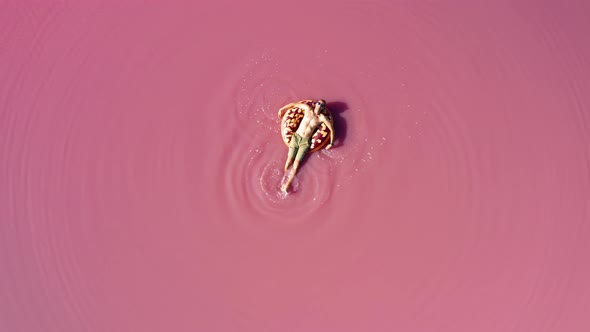 Aerial View of a Man in a Pink Lake