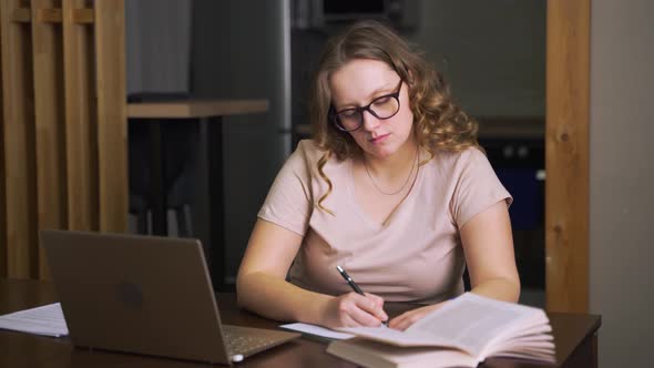 Woman Tears Piece of Paper Out of Her Notebook and Throws It Away