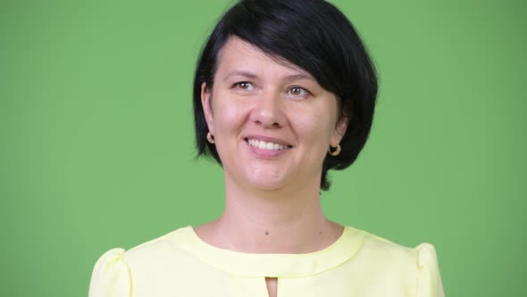 Beautiful Businesswoman with Short Hair Smiling and Thinking