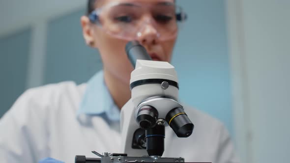 Close Up of Scientist Checking Microscopic Tool