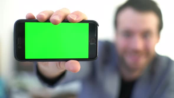 Man showing off multimedia smartphone display