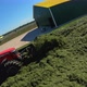Copter flying around tractors in a silo on a farm - VideoHive Item for Sale