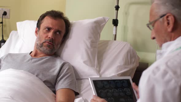 Anxious Sick Man Hearing Bad News From Physician