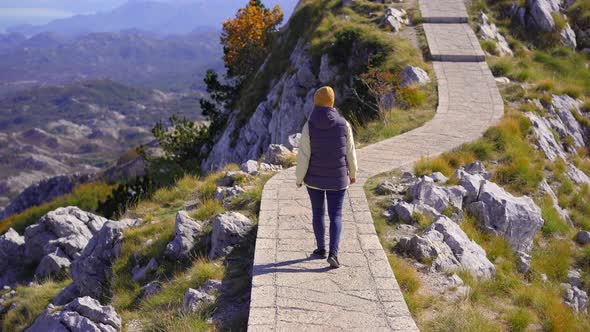 A Young Woman Traveler Visits the View Point on the Top of the Lovcen Mountain