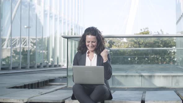 Happy Excited Businesswoman Using Laptop Outside