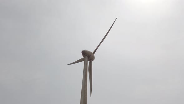 Looking up towards a spinning windmill