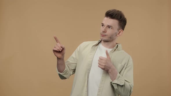 Portrait of Stylish Guy Pointing Side Hand for Something Then Nods and Shows Thumb Like