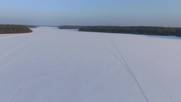 Flight Over a Taiga Forest Lake in Winter