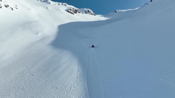 Snowmobile high in the mountains aerial view 4 K