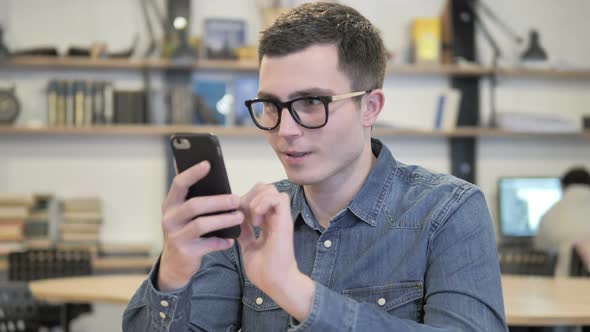 Young Man Using Smartphone Text Messaging