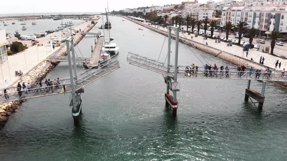 Pedestrian Drawbridge of Marina de Lagos, Faro in Algarve - Low angle Fly-over Aerial