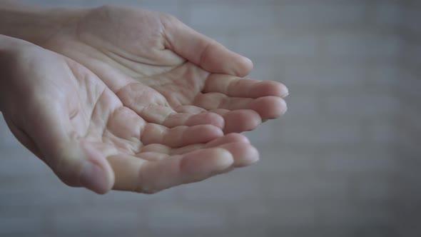 Hands of a begging woman.