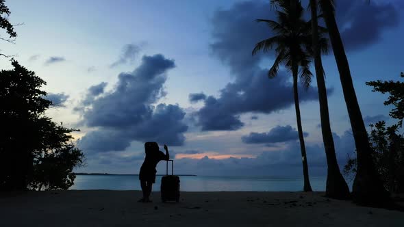 Tourist posing on exotic island beach vacation by clear lagoon with white sandy background of the Ma