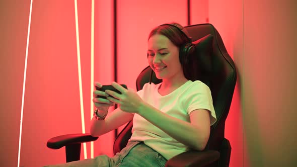 Portrait of Addicted Crazy Funny Funky Teenager Girl Use Her Smartphone Play Game