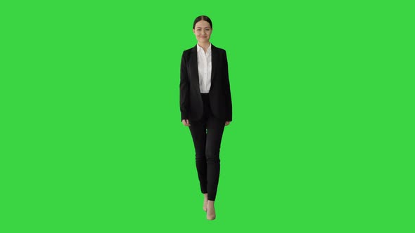 Confident Businesswoman Walking Towards Looking at Camera with a Smile on a Green Screen, Chroma Key