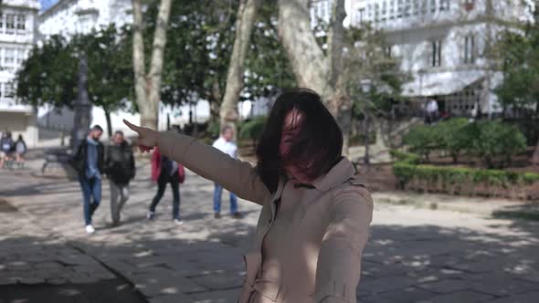 A Girl in the Park is Talking on the Phone