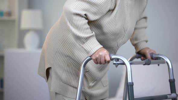 Elderly Lady Using Walking Frame, Rehabilitation After Joint Trauma, Close Up