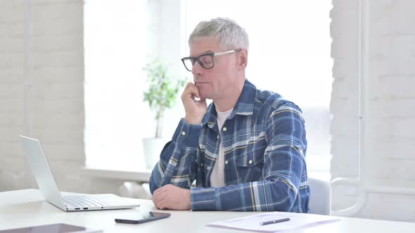 Tired Casual Middle Aged Man Taking Nap in Office 