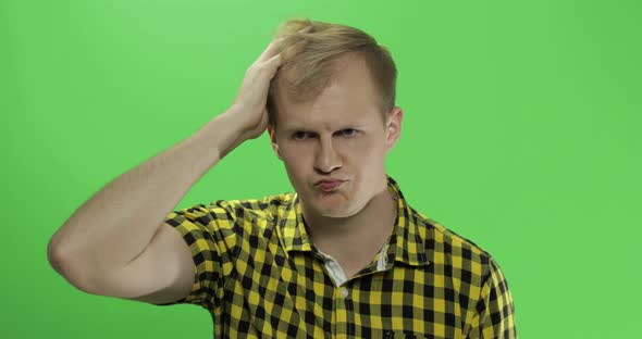 Handsome Thoughtful Man in Yellow Shirt Looking in the Camera and Thinks