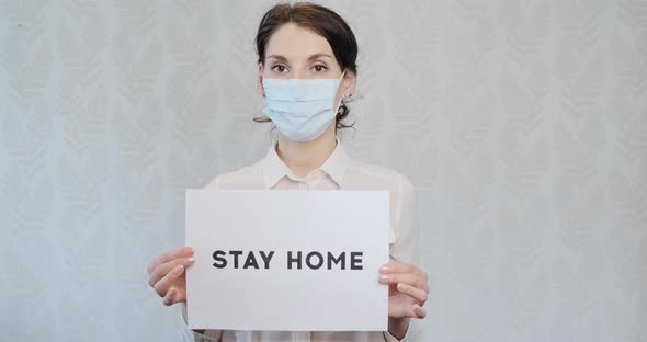 Young Girl in Medical Mask, Being at Home, To Urge Help To Doctors, Showing Poster with the