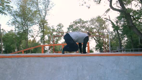 Young Man Doing Parkour Tricks in Extreme Sports Park