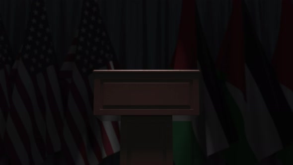 Many Flags of Jordan and the USA Behind Speaker Tribune