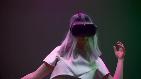 Addicted Woman Gaming Moving in Invisible Space Using VR