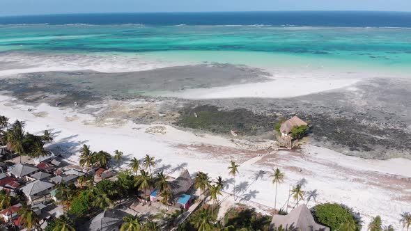The Rock Restaurant in Ocean Built on Stone at Low Tide on Zanzibar Aerial View