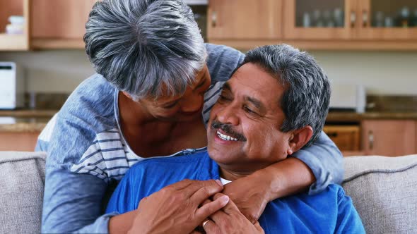 Senior couple embracing each other in living room 4k