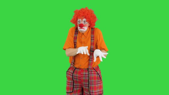 Clown Playing Imaginary Piano with Emotions on a Green Screen Chroma Key