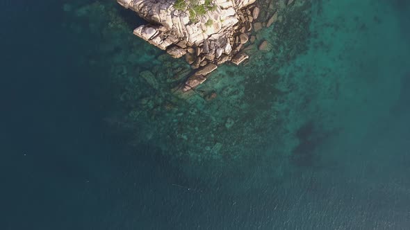 Flying over Small Island in Ocean
