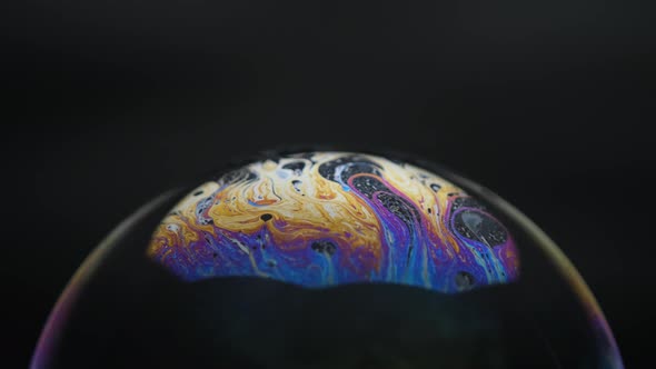 Soap bubbles isolated on black background. Abstract soap bubbles with colorful reflections.