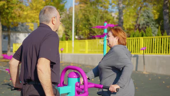 Active Elderly Couple Exercising Outdoors in a Park or Garden