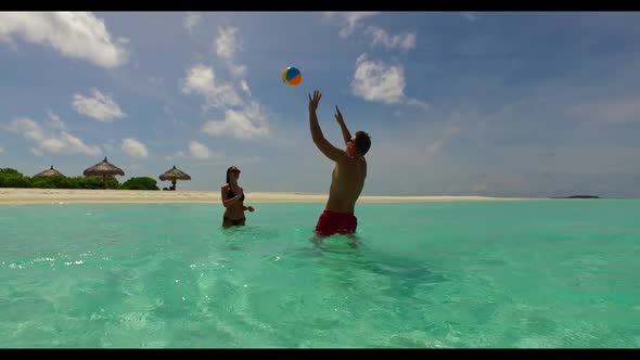 Two people in love on relaxing shore beach trip by clear water with white sand background of the Mal