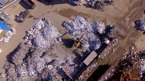 Aerial view topdown claw crane loader handling metal waste