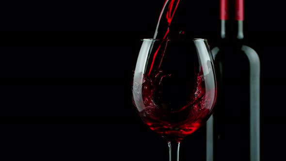 Super Slow Motion Shot of Pouring Red Wine on Black Background at 1000Fps
