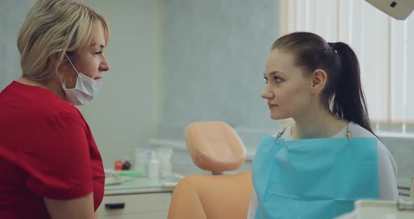 Cute Dentist Tells the Patient About the Rules of Oral Care