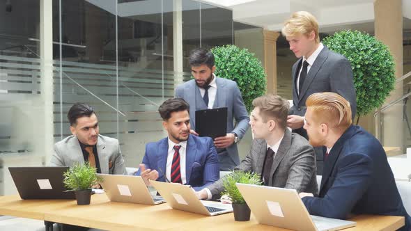 Team of Busy Young Business People in Meeting at Office