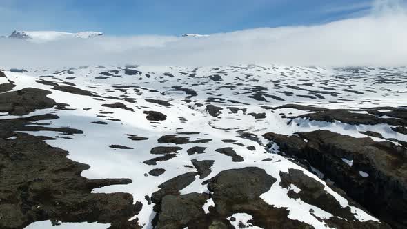 Aerial Flying Over Snow Covered Highland Landscape In Norway. Dolly Right, Establishing Shot