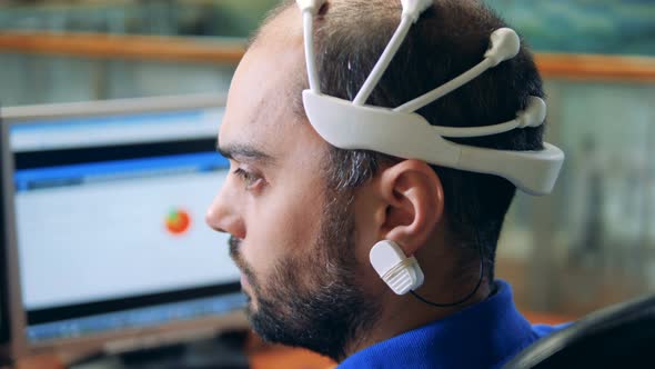 An Engineer Wearing Special Brainwave Scanning Sensors on a Head, Back View