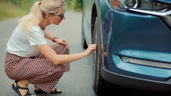 Frustrated Woman Repairing Flat Tire Check Pressure Accident Car. Broken Vehicle Damage Troubles.