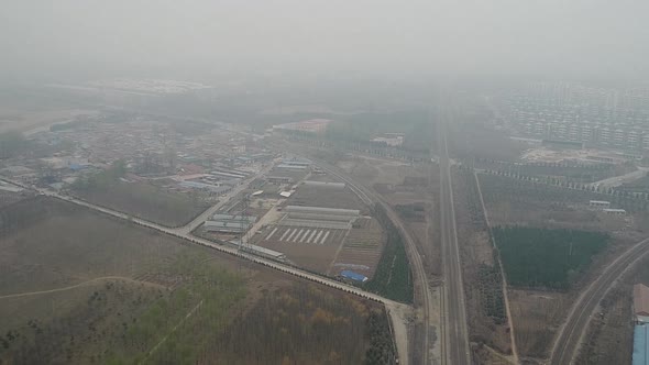 Rural Poor Village Outside Beijing with Farmland and Train Tracks During Extreme Pollution Day