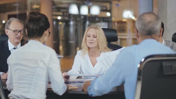 Corporate Business Team and Mature Female Manager in Meeting Room