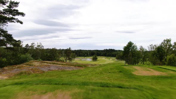 Unrecognizable professional golfer hits ball on golf course of Molndal near Gothenburg, Sweden. Aeri