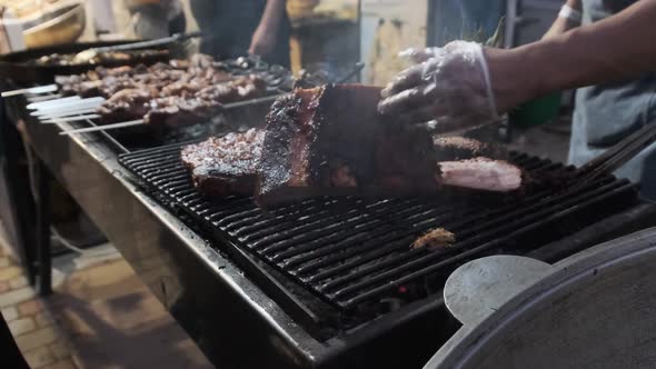 Meat Is Grilled at Street Food Festival. Large Pieces of Pork Roasted on the BBQ