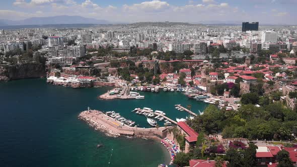Flight over old town with sea port of Antalya City