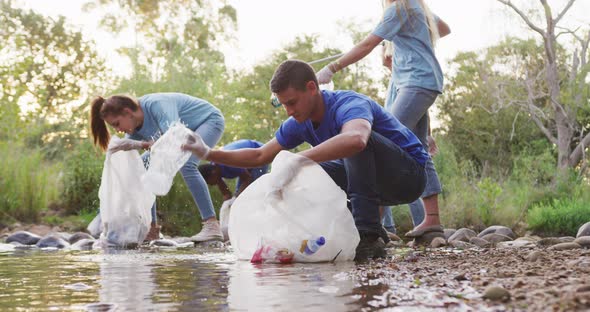 Mid adults volunteering during river clean-up day