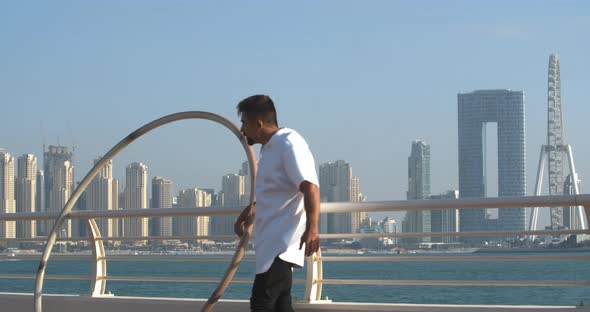 Wheel Gymnast is Leaning on the Railing Ain Dubai in the Background