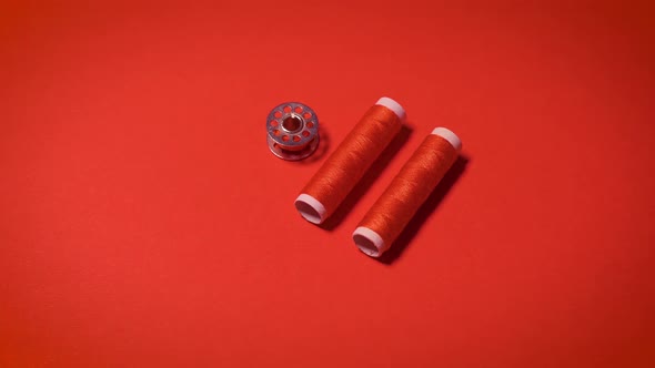 Threads and Zipper on a Red Minimalistic Background